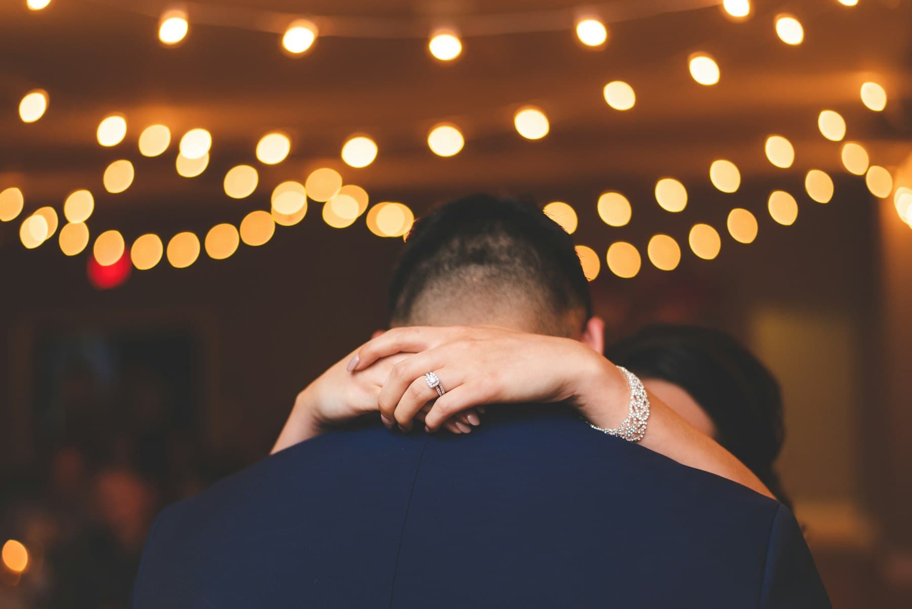 A couple at night under warm lights
