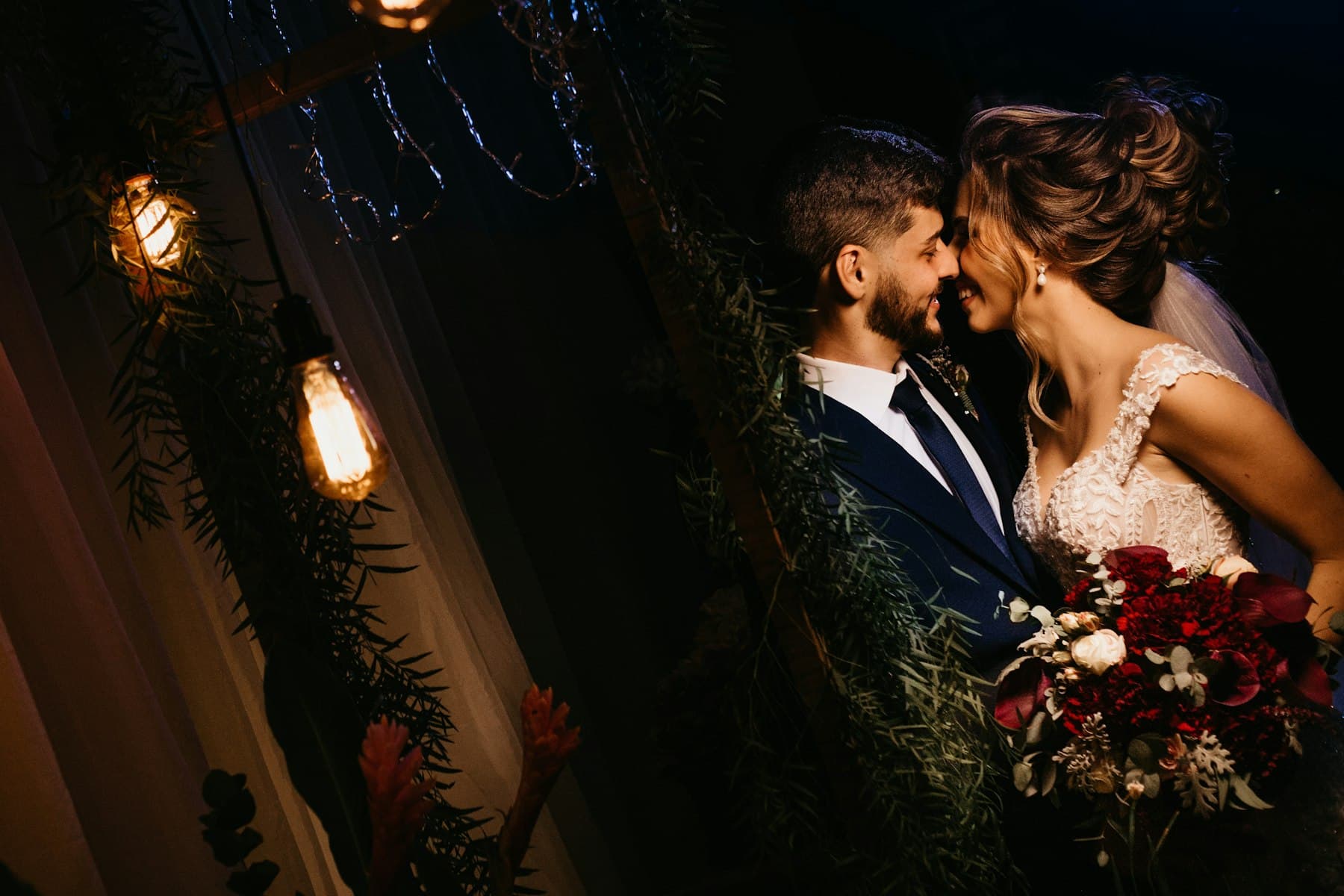 Couple under string lights at night